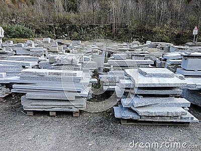 Stacks of industrial slabs of granite placed in a yard Stock Photo