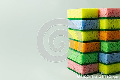 stacks of multicolored sponges on grey Stock Photo