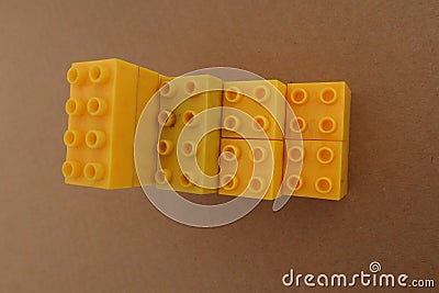 Stacks of one color lego with a brown cardboard background Stock Photo
