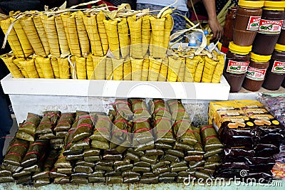 Stacks of Suman sa Ibos and Suman sa Lihiya and other local sweet delicacies sold at a souvenir shop Editorial Stock Photo