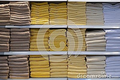 Stacks of towels on a store shelf. Showcase with textiles for personal hygiene Stock Photo