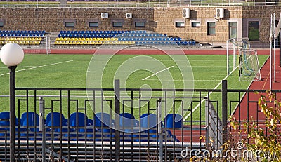 Stadium part with sits and football field Stock Photo