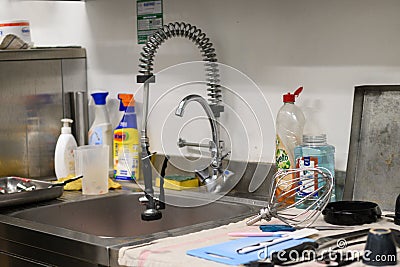 staff cleaning professional cook appliances and ware in professional kitchen Editorial Stock Photo