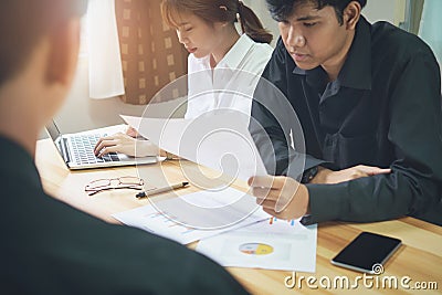 The staff is consulting with customers who use their business services. Stock Photo