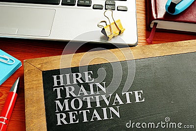 Staff hire, train, motivate and retain written on blackboard Stock Photo