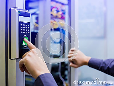 Staff push down electronic control machine with finger scan to access the door of control room or data center. The concept of data Stock Photo