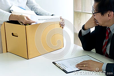 Staff worker hold the box and send resignation letter to boss Stock Photo