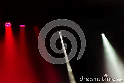 Stage lights. Several projectors in the dark. Multi-colored light beams from the stage spotlights on the stage in the smoke at the Stock Photo