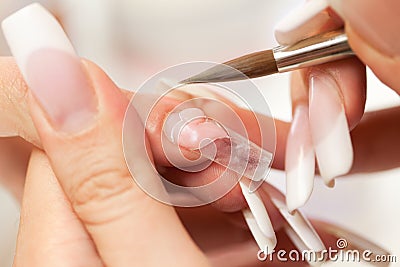 Stage of manicure: modeling of nail with acryl Stock Photo