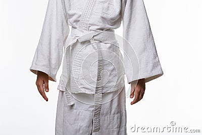 Stages of correct tying of the belt by a teenager on a sports kimono, step ten is the final step Stock Photo