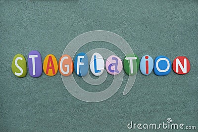 Stagflation, economic term composed with multi colored stone letters over green sand Stock Photo