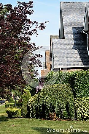 Staggered rooflines of suburban neighborhood homes with landscaping Stock Photo