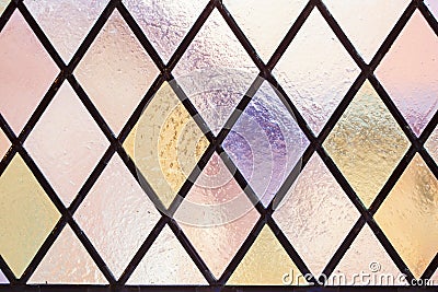 Stained glass with multi colored diamond pattern as background Stock Photo