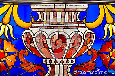 The stained glass window is bright and beautiful in the form of a vase of blue red yellow yellow. World tourism flowers Stock Photo