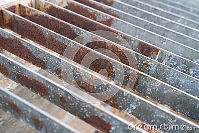 Stained steel grill sewer cover or sewage drain cover, close up image Stock Photo