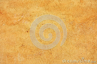 Stained, textured, yellow colored concrete wall Stock Photo