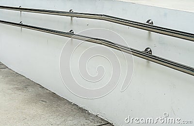 Stainless railing on white wall Stock Photo
