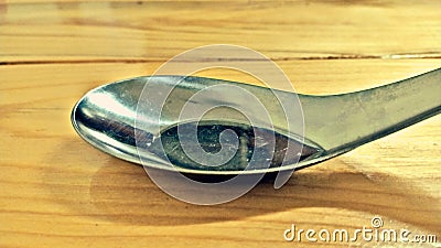 Stainless spoon put on wood background Stock Photo