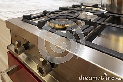 Stainless steel range / oven ketchen appliance burners and buttons with marble counter top Stock Photo