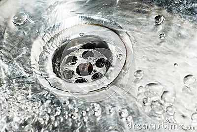 Stainless steel sink plug hole close up Stock Photo