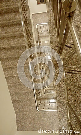 Stainless steel handrail with steel balustrades in high rise commercial building from midlanding slab to cover tread and riser Stock Photo