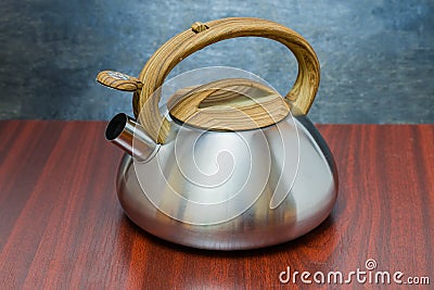 Stainless steel stovetop kettle with open steam whistle on spout Stock Photo