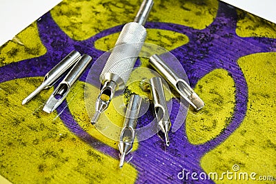 Stainless steel tattoo tube and tips with warning Stock Photo