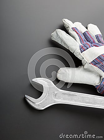 Stainless steel wrench and work glove Stock Photo