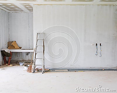 Stair aluminum leaning wall in building construction site with gypsum board ceiling structure and plaster mortar Stock Photo