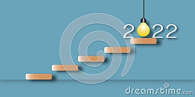 Stair with light bulb in the year 2022 on blue background. Stock Photo