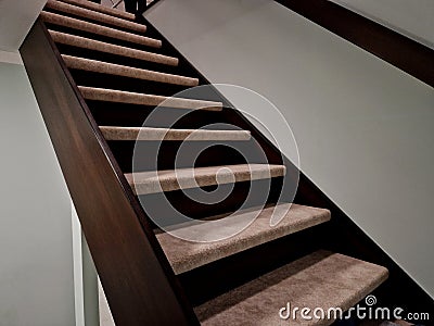 the staircase in the house is lined with carpeted stairs. the carpet is Stock Photo