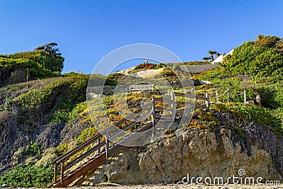 Staircase leading to El Matador Beach in Malibu California in the foreground and blue skies on a clear sunny day. Concept, leisure Stock Photo