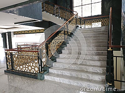 a staircase with an octagonal patterned railing in a large Mosque Stock Photo