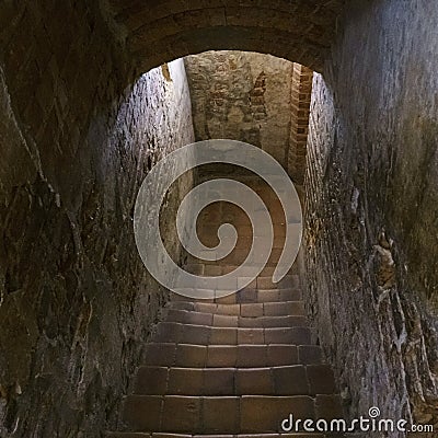 Staircase in an old castle going to the dungeon. Medieval and gothic concept. Stock Photo