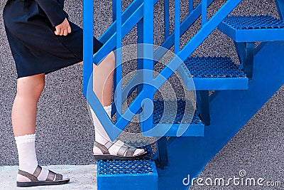 staircase. Schoolgirl climbs the stairs. Stock Photo