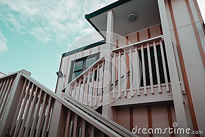 staircase with wooden railing in nice old white house with square window in lonely quiet suburban town, west Stock Photo