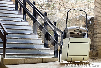 Stairlift for disabled and elderly people to climb stairs at arc Stock Photo