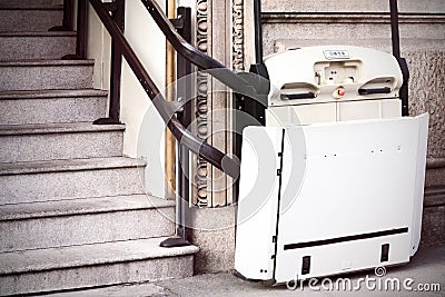 Stairlift on staircase for elderly people and disabled persons Stock Photo