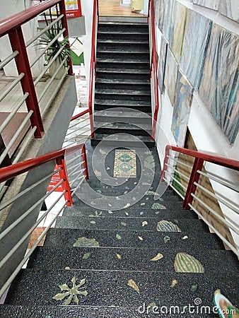 stairs, black color with leaves and iron painted red and white Stock Photo