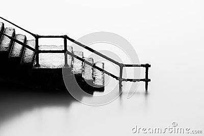 Stairs going down into sea Stock Photo