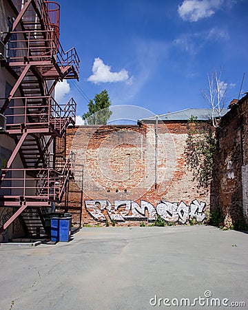 Brick wall at the factory yard at summer Stock Photo