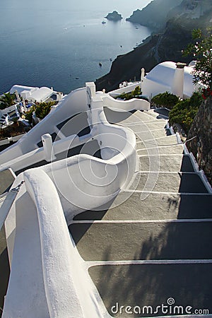 Stairs on Santorini slope going down to the sea Stock Photo