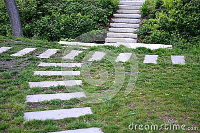 Stairs to the deep riverbed on both sides formed by light concrete stairs, which are also seats. in between is an improvised footb Stock Photo