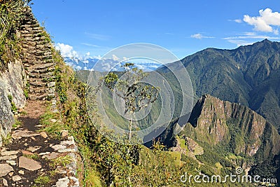 Stairs of trail with Machu Picchu far below in the Stock Photo