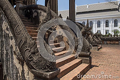 Stairway decorated with naga statues in the temple Haw Phra Kaew of Vientiane, Laos Stock Photo