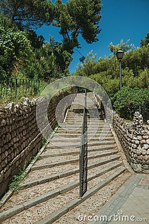 Stairway with iron handrail going towards a garden in Madrid Stock Photo