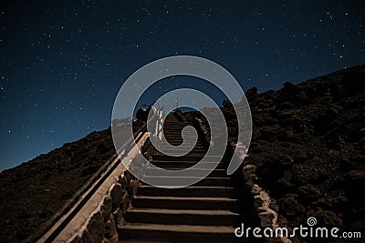 Stairway leading up to the night sky Stock Photo