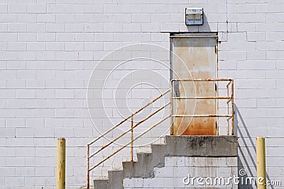 Stairway to rusty door Stock Photo