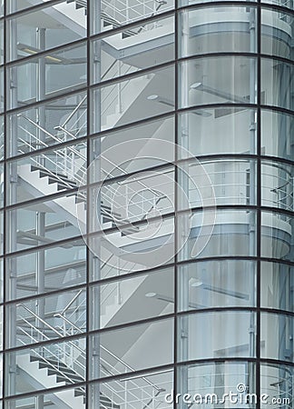 Stairways between the floors of a futuristic modern commercial building behind a curved glass facade Stock Photo