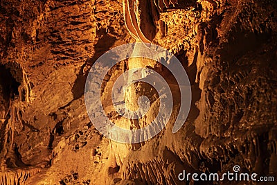 Stalagmite with color light in the cave Stock Photo